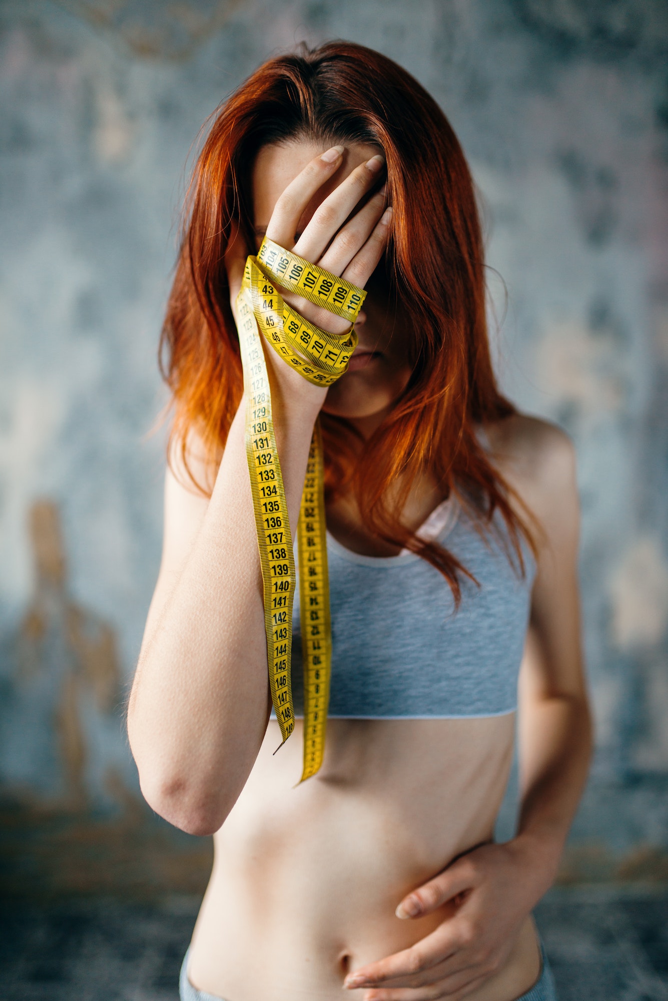 Skinny woman, hands tied in measuring tape